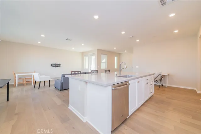 a kitchen with kitchen island wooden cabinets and dining table