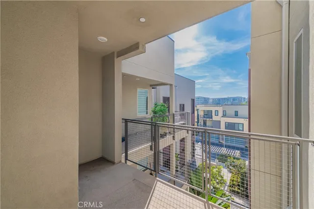 a bed sitting in a spacious bedroom next to a window
