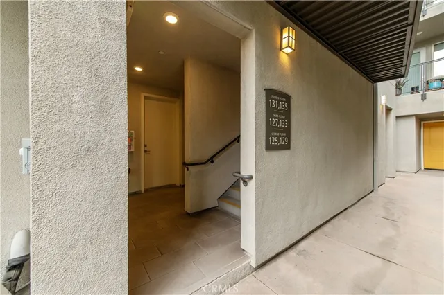 a view of a building with a garden and pathway