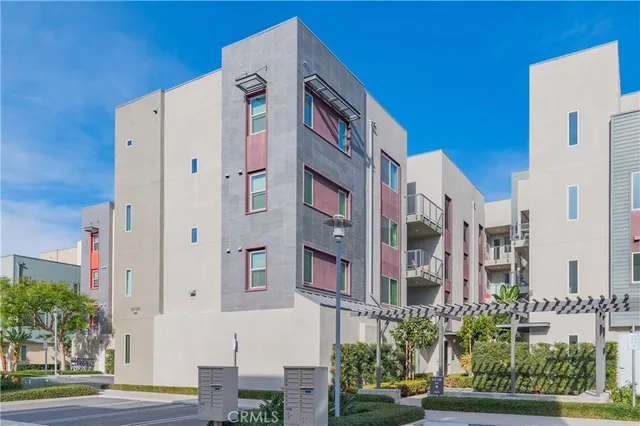 a view of a building with a garden and pathway