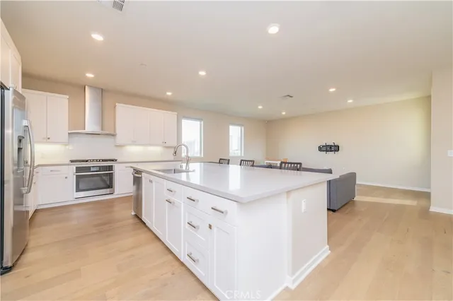 a living room with kitchen island furniture and a view of kitchen