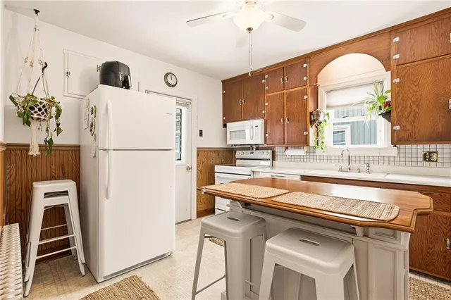 a kitchen with a refrigerator a sink and cabinets