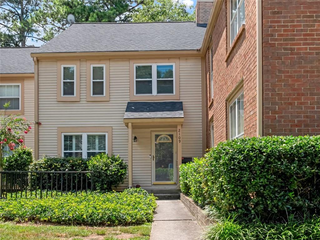 a view of a house with brick walls and potted plants
