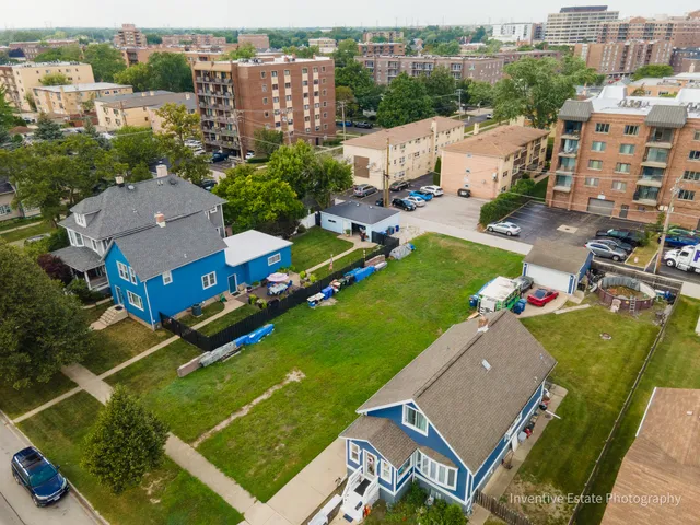 an aerial view of multiple houses with yard