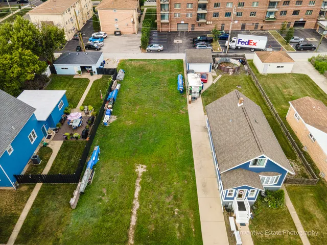 an aerial view of a swimming pool with a yard and mountain view