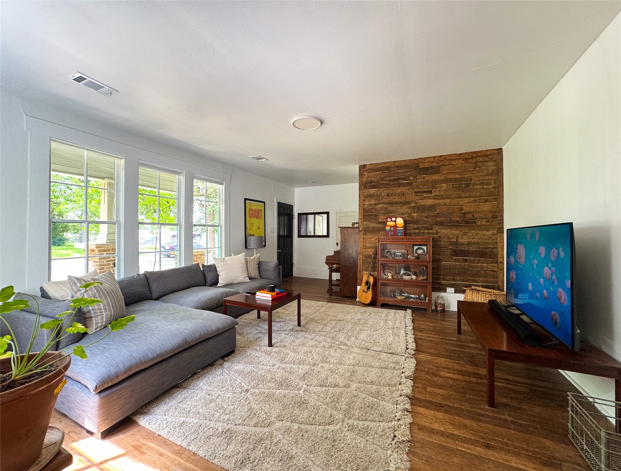 200 East Brenham Street Elgin, TX 78621 - Photo 25 of 40 Second living room space featuring wood floors and wood accent wall