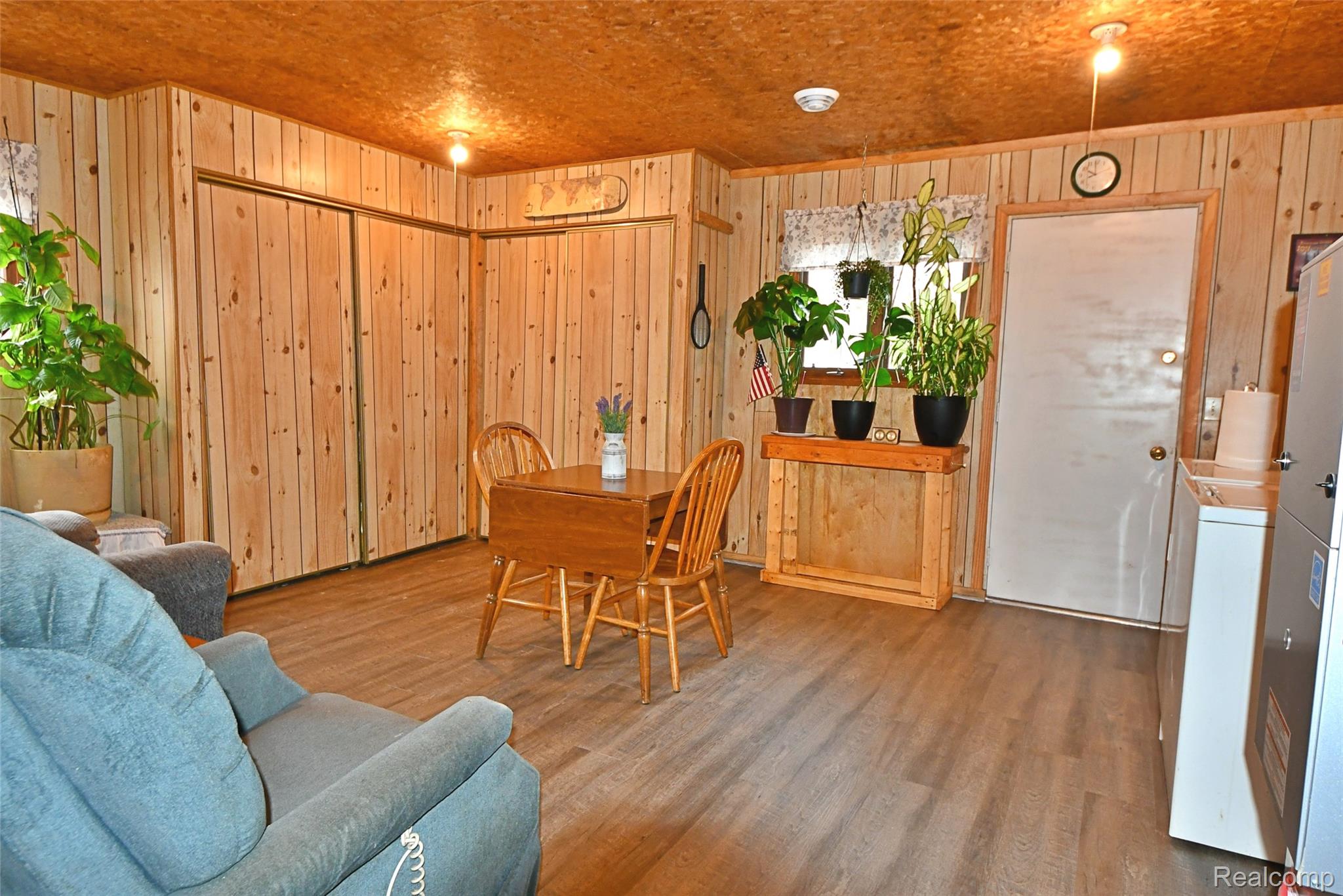 10456 Austin Road St. Helen, MI 48656 - Photo 7 of 24 Dining space featuring wood finished floors, washer / clothes dryer, and wooden walls