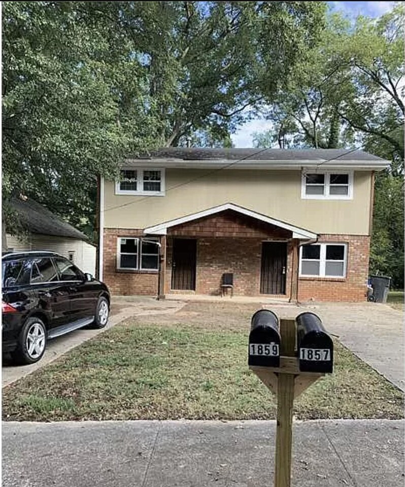 1859 Williams Avenue East Point, GA 30344 - Photo 1 of 1 a front view of a house with parking space