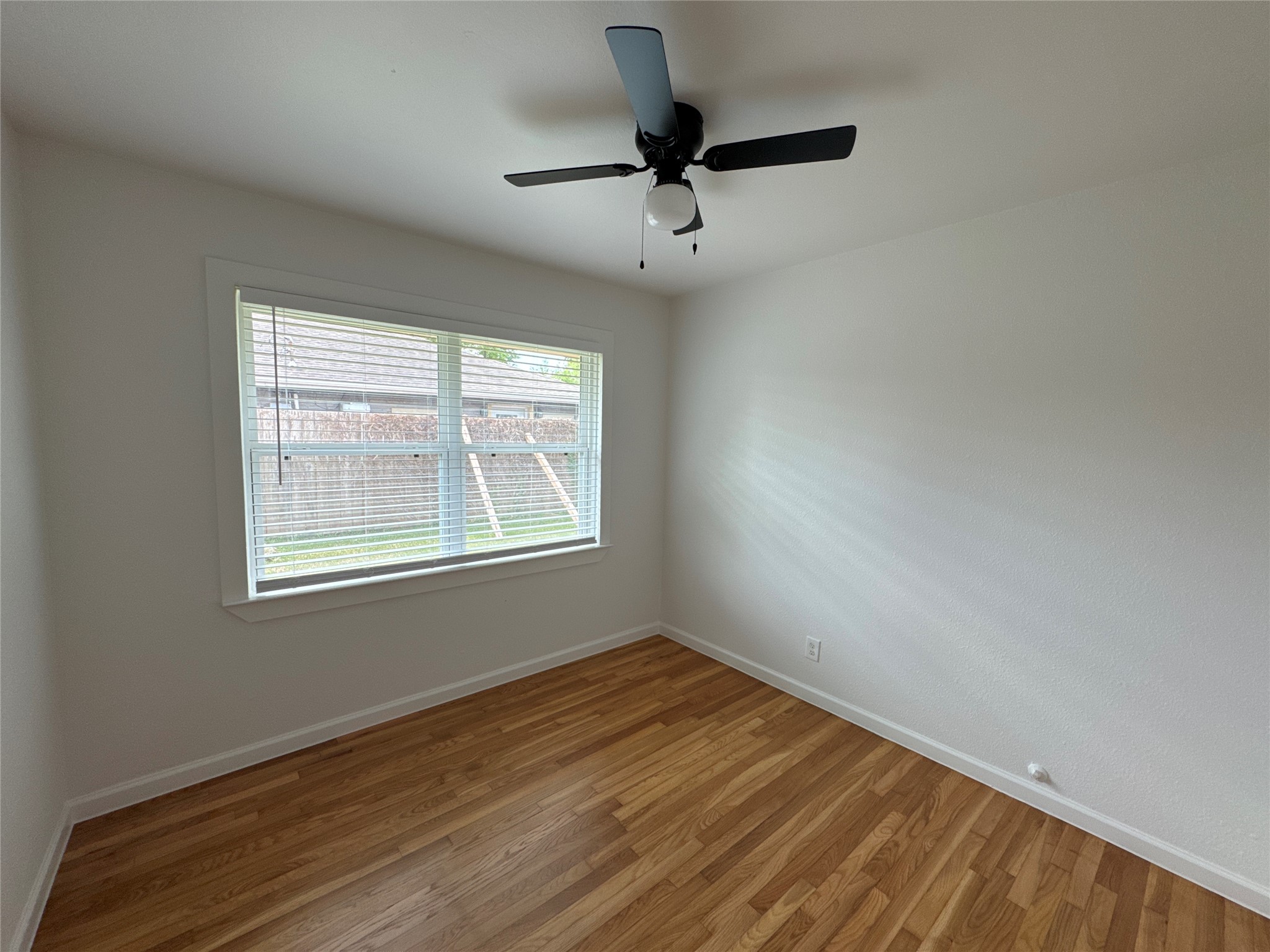 8733 Lugary Drive Houston, TX 77074 - Photo 26 of 30 a view of an empty room with wooden floor and a window