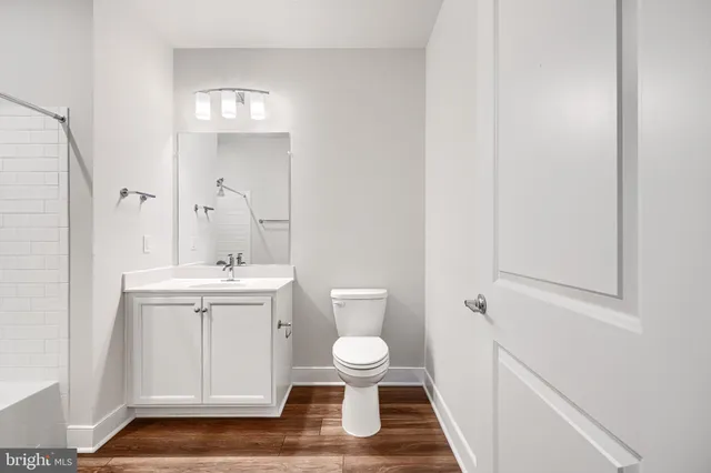 a bathroom with a sink a toilet a mirror and vanity