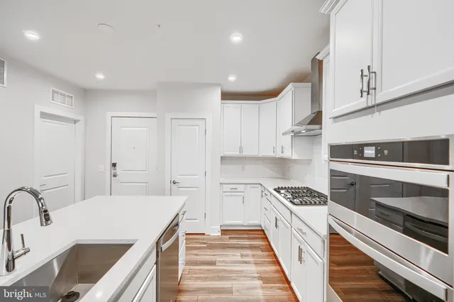 a kitchen with granite countertop a sink and cabinets