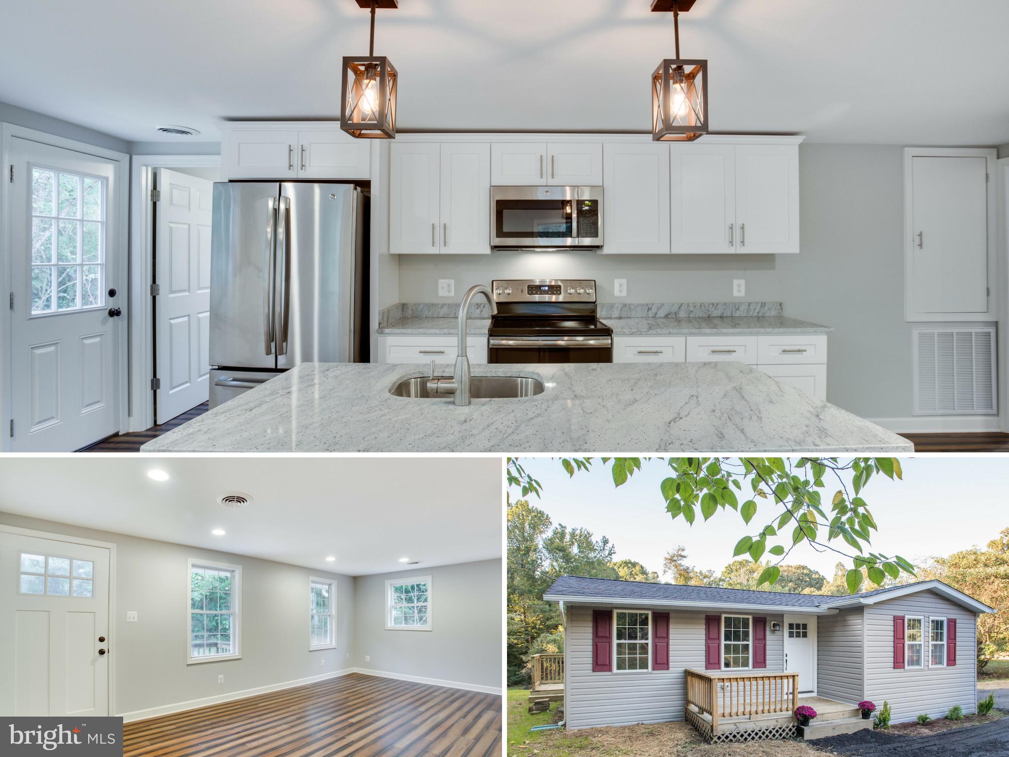 a kitchen with stainless steel appliances granite countertop a sink a stove and a refrigerator
