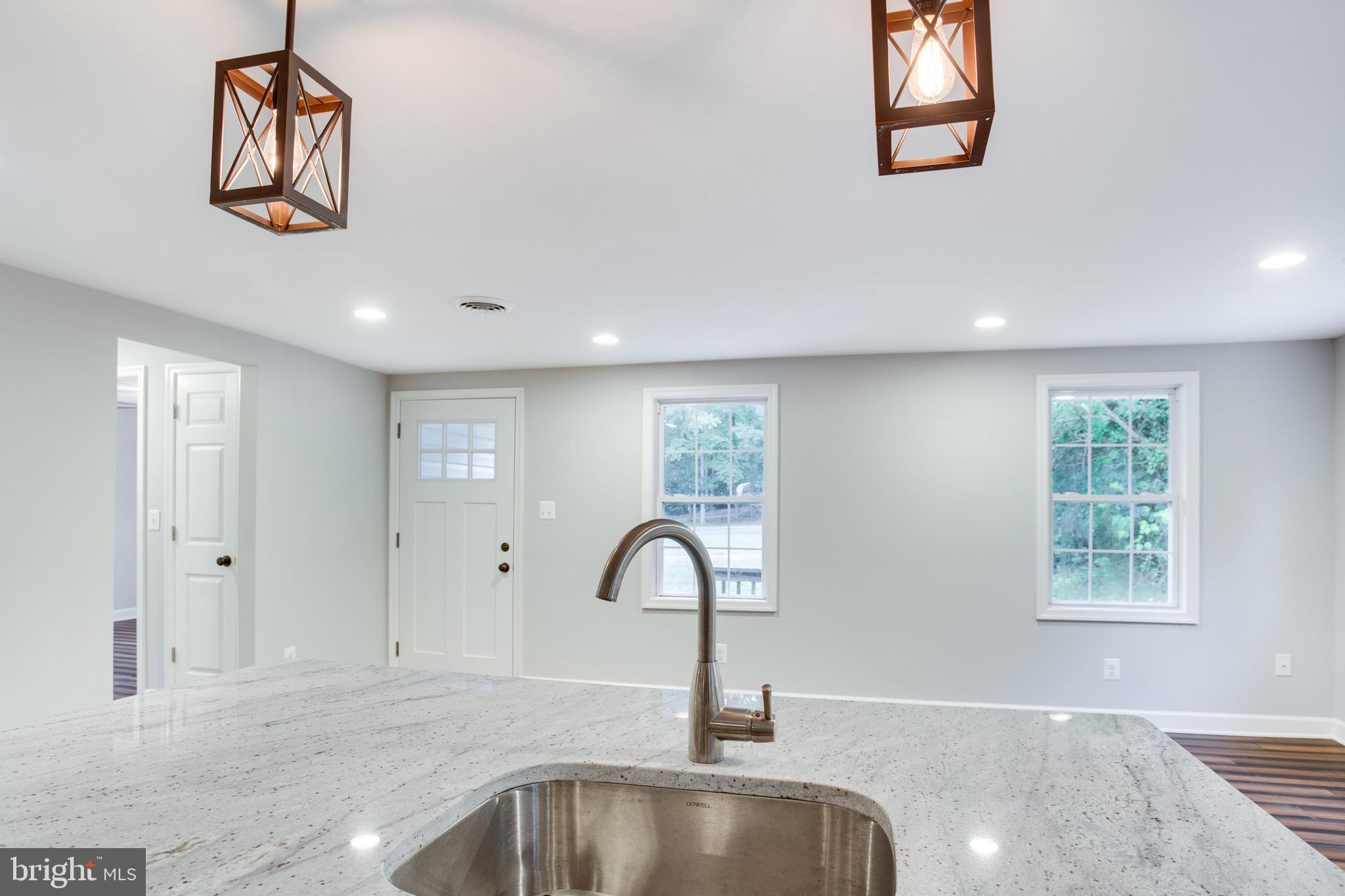 5601 Cherry Hill Road Huntingtown, MD 20639 - Photo 11 of 37 a view of a kitchen with a sink and a window