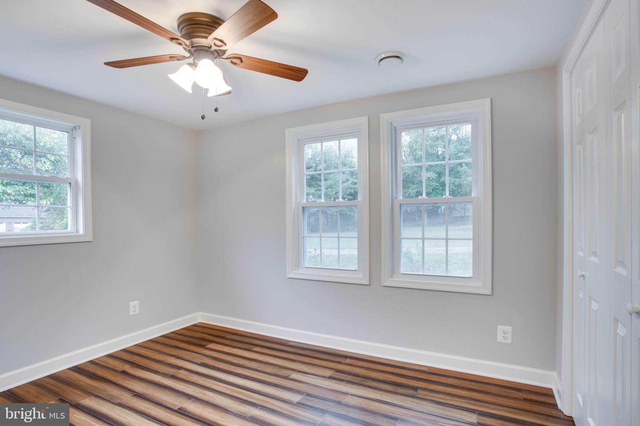 5601 Cherry Hill Road Huntingtown, MD 20639 - Photo 12 of 37 a view of an empty room with a window and wooden floor