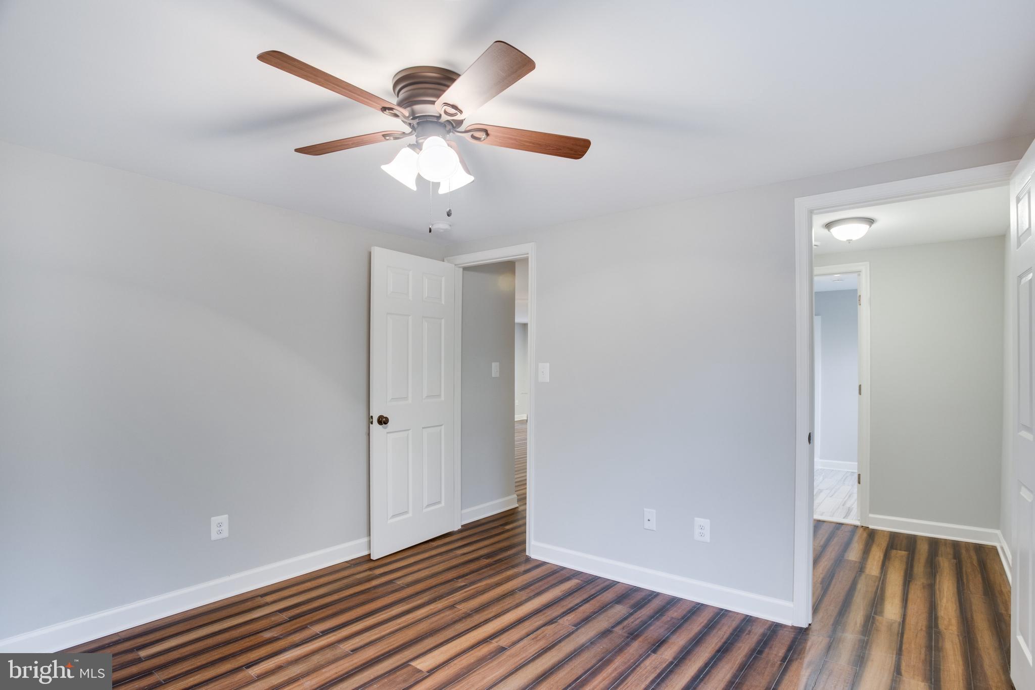 5601 Cherry Hill Road Huntingtown, MD 20639 - Photo 13 of 37 a view of an empty room with wooden floor