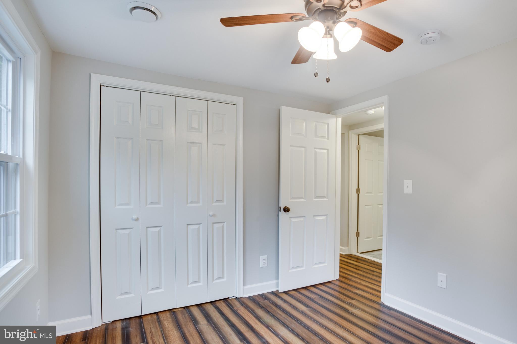 5601 Cherry Hill Road Huntingtown, MD 20639 - Photo 14 of 37 a view of empty room with wooden floor and fan