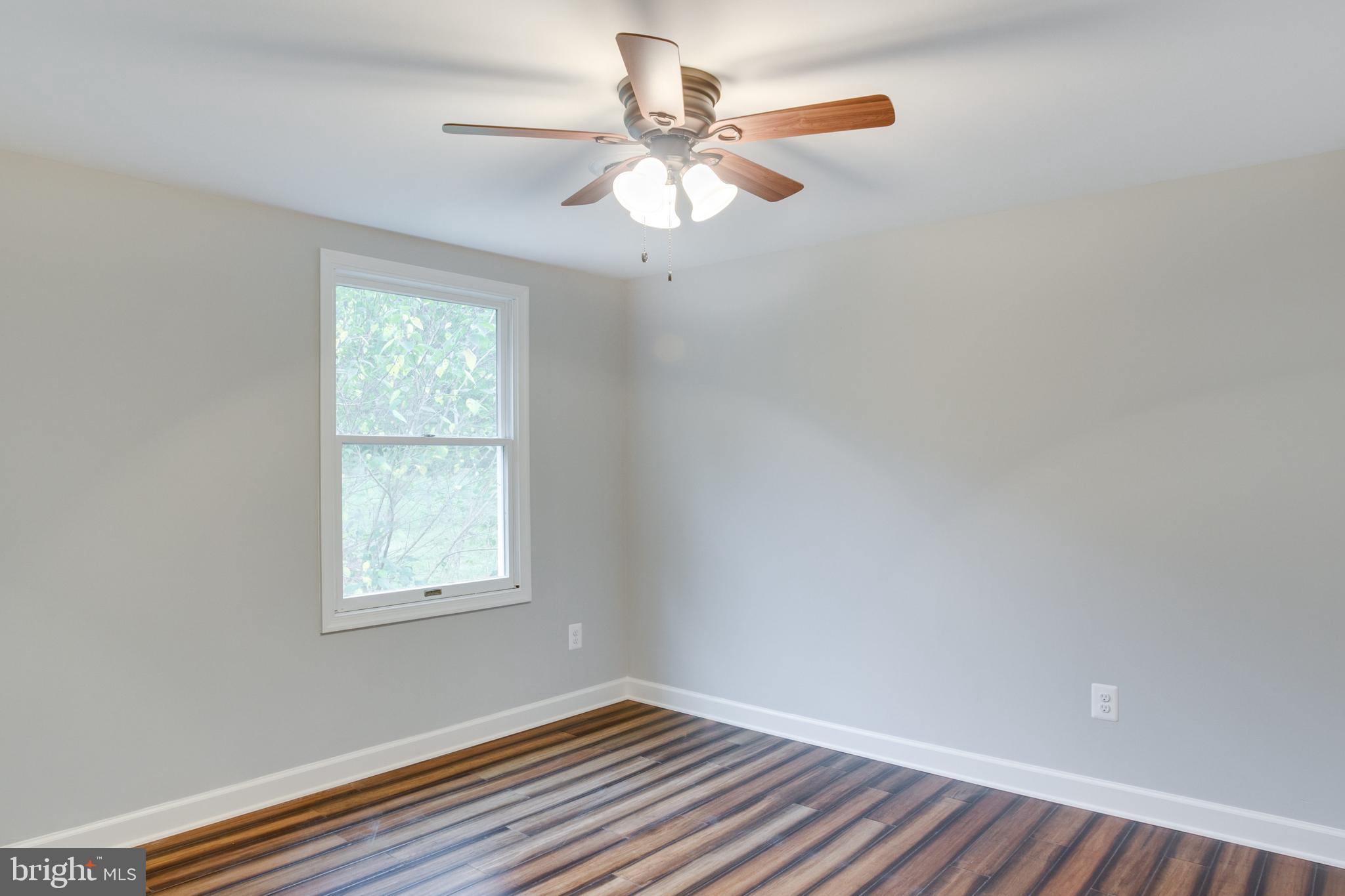 5601 Cherry Hill Road Huntingtown, MD 20639 - Photo 18 of 37 an empty room with a window and a fan