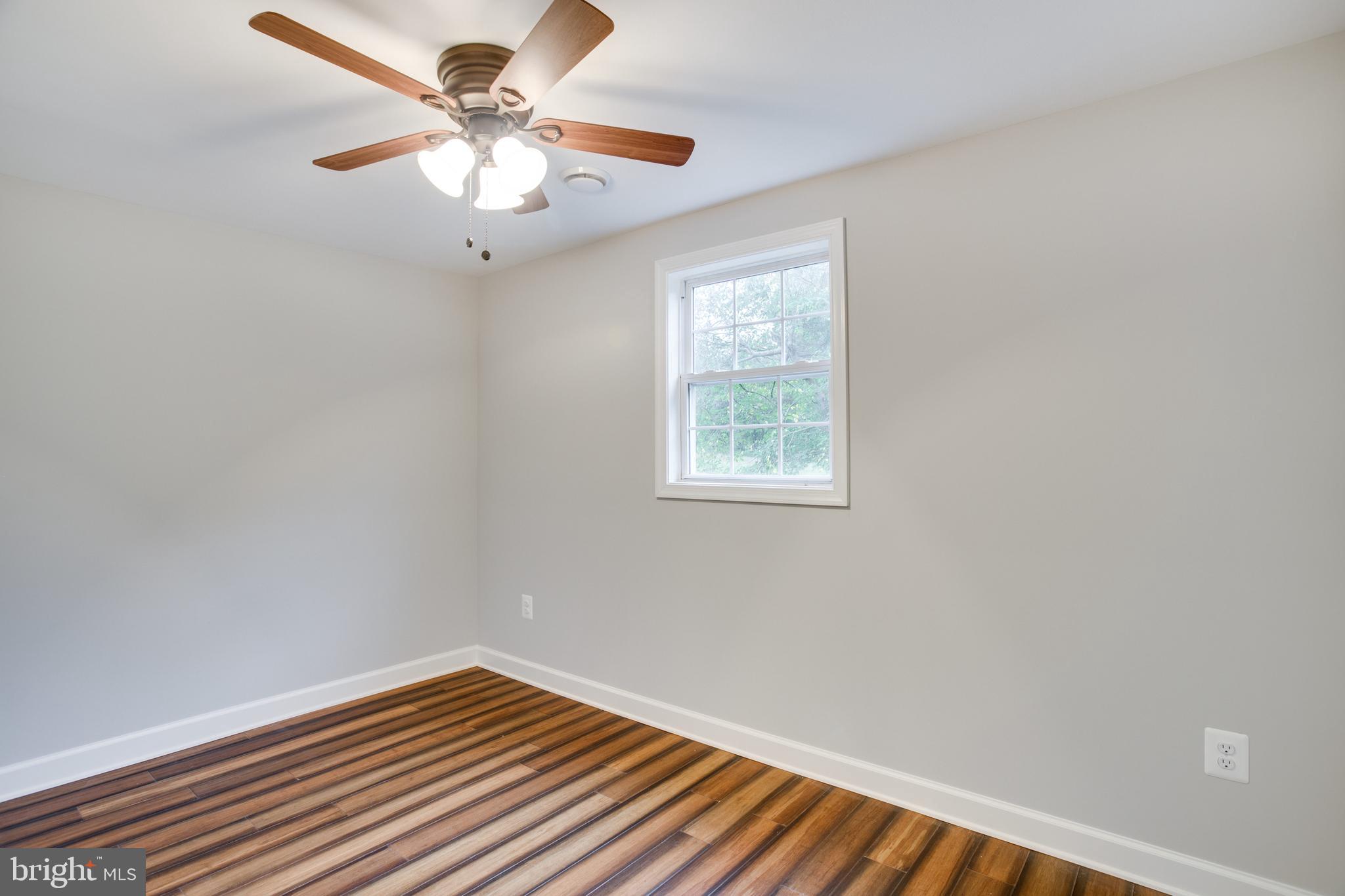 5601 Cherry Hill Road Huntingtown, MD 20639 - Photo 19 of 37 an empty room with a window and a fan
