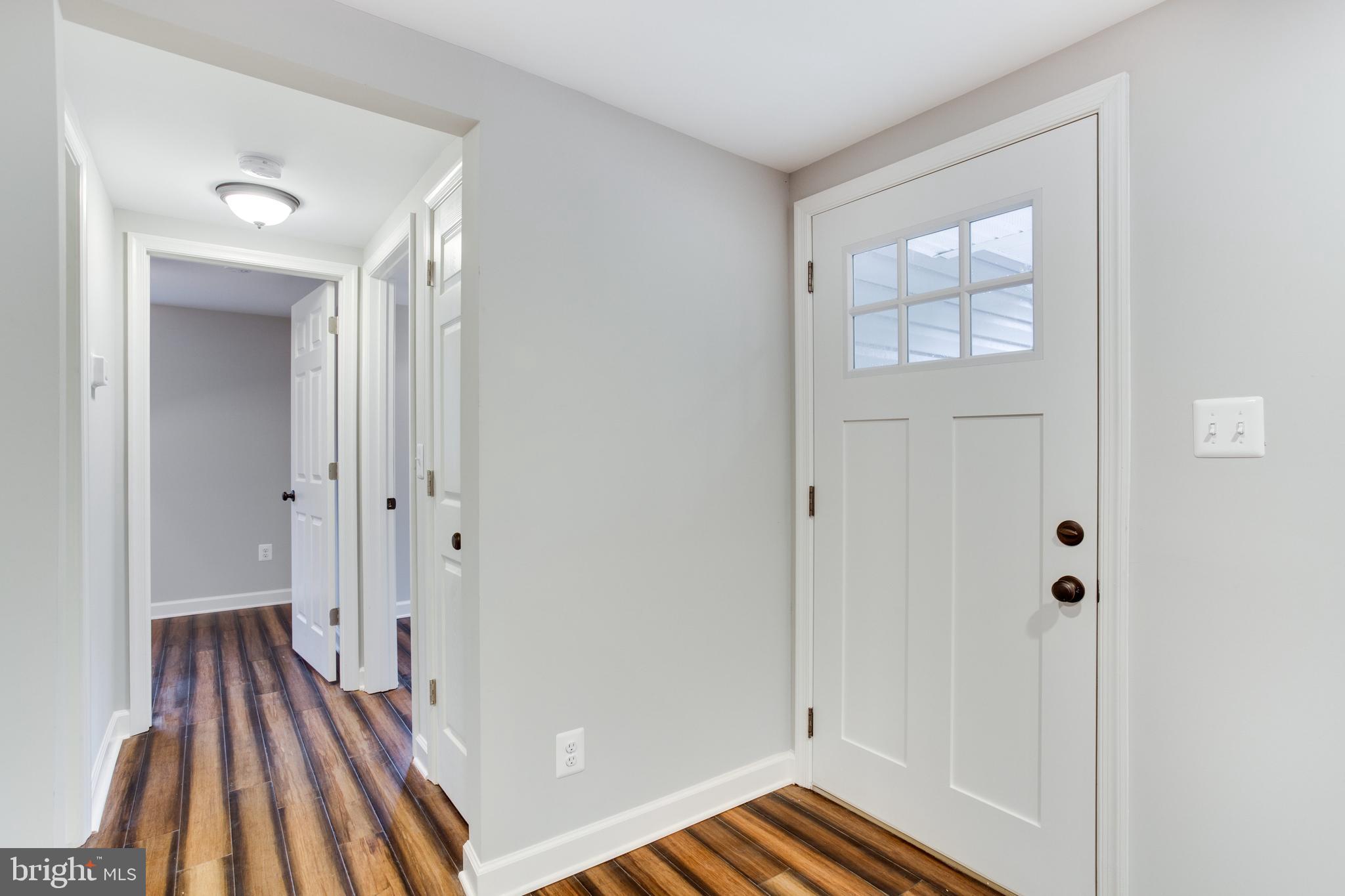 5601 Cherry Hill Road Huntingtown, MD 20639 - Photo 36 of 37 a view of a hallway with wooden floor and staircase