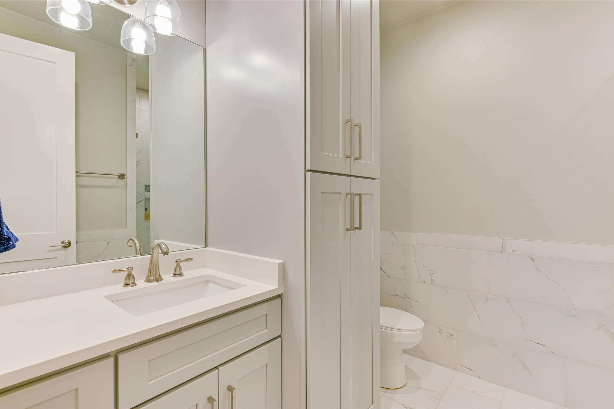 2308 Kellie Brooke Road, Unit 13 Spicewood, TX 78669 - Photo 12 of 19 Bathroom featuring a vanity with a white countertop, a mirror, and a toilet