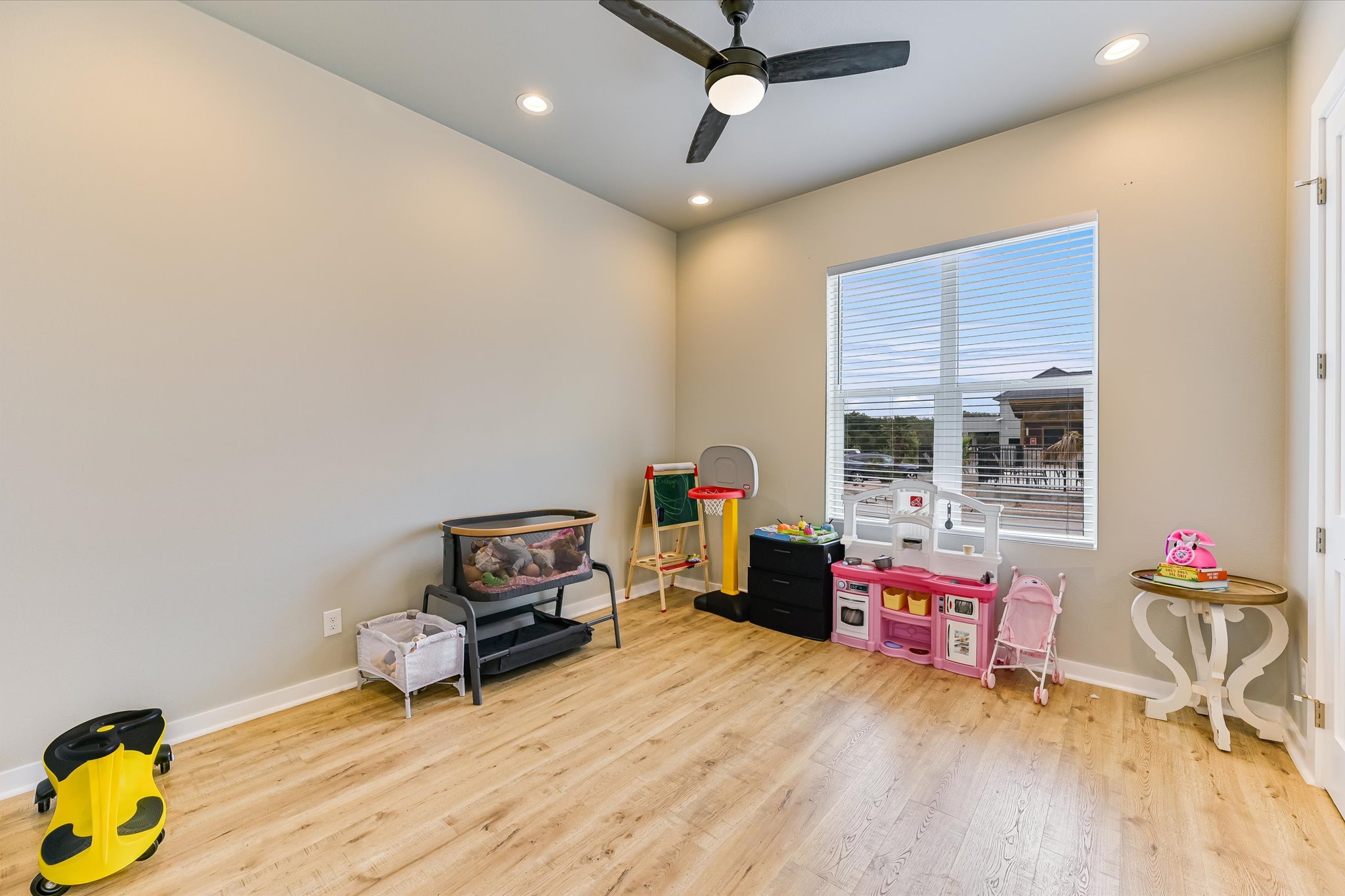 2308 Kellie Brooke Road, Unit 13 Spicewood, TX 78669 - Photo 13 of 19 Room featuring light-toned walls, a window with blinds, recessed lighting, and a ceiling fan