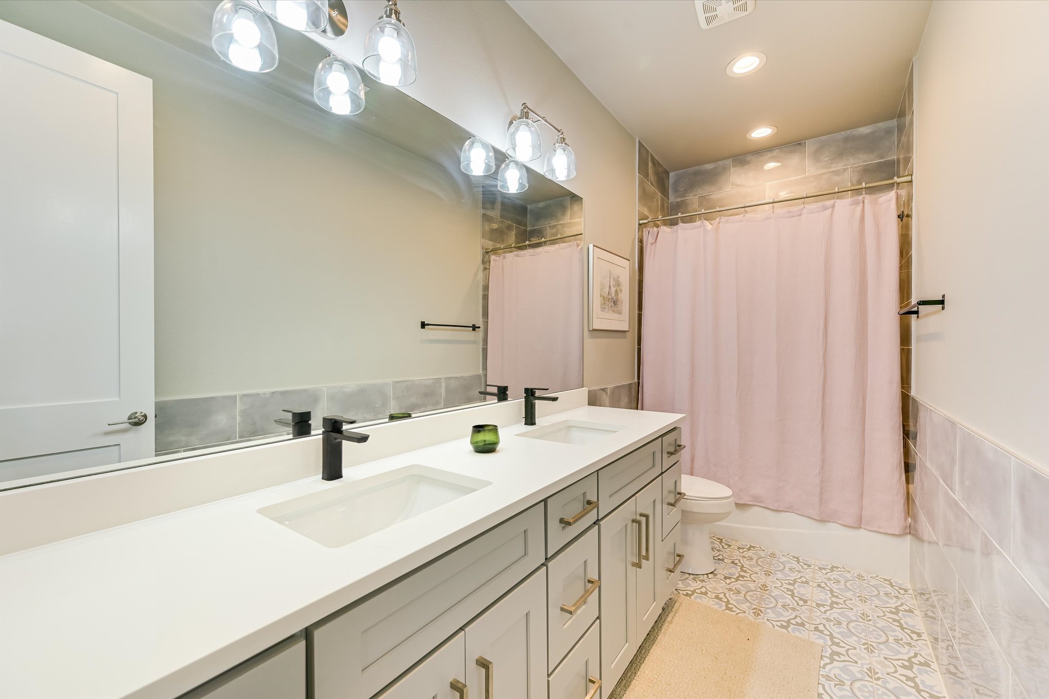 2308 Kellie Brooke Road, Unit 13 Spicewood, TX 78669 - Photo 14 of 19 This bathroom features a double vanity with white countertops, light gray cabinetry, and matte black faucets