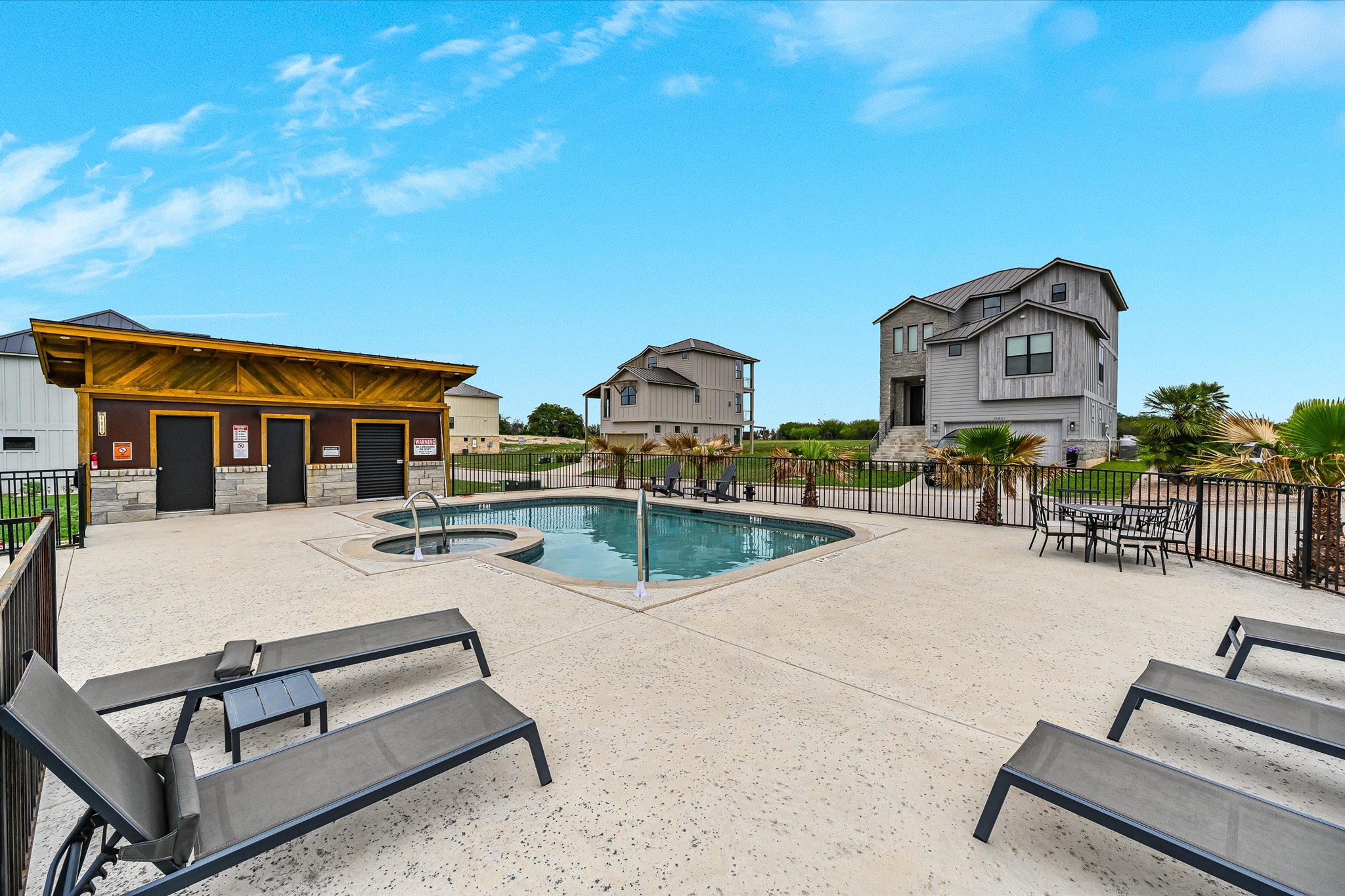 2308 Kellie Brooke Road, Unit 13 Spicewood, TX 78669 - Photo 18 of 19 The community features an outdoor swimming pool, a separate spa, and a pool deck with lounge chairs