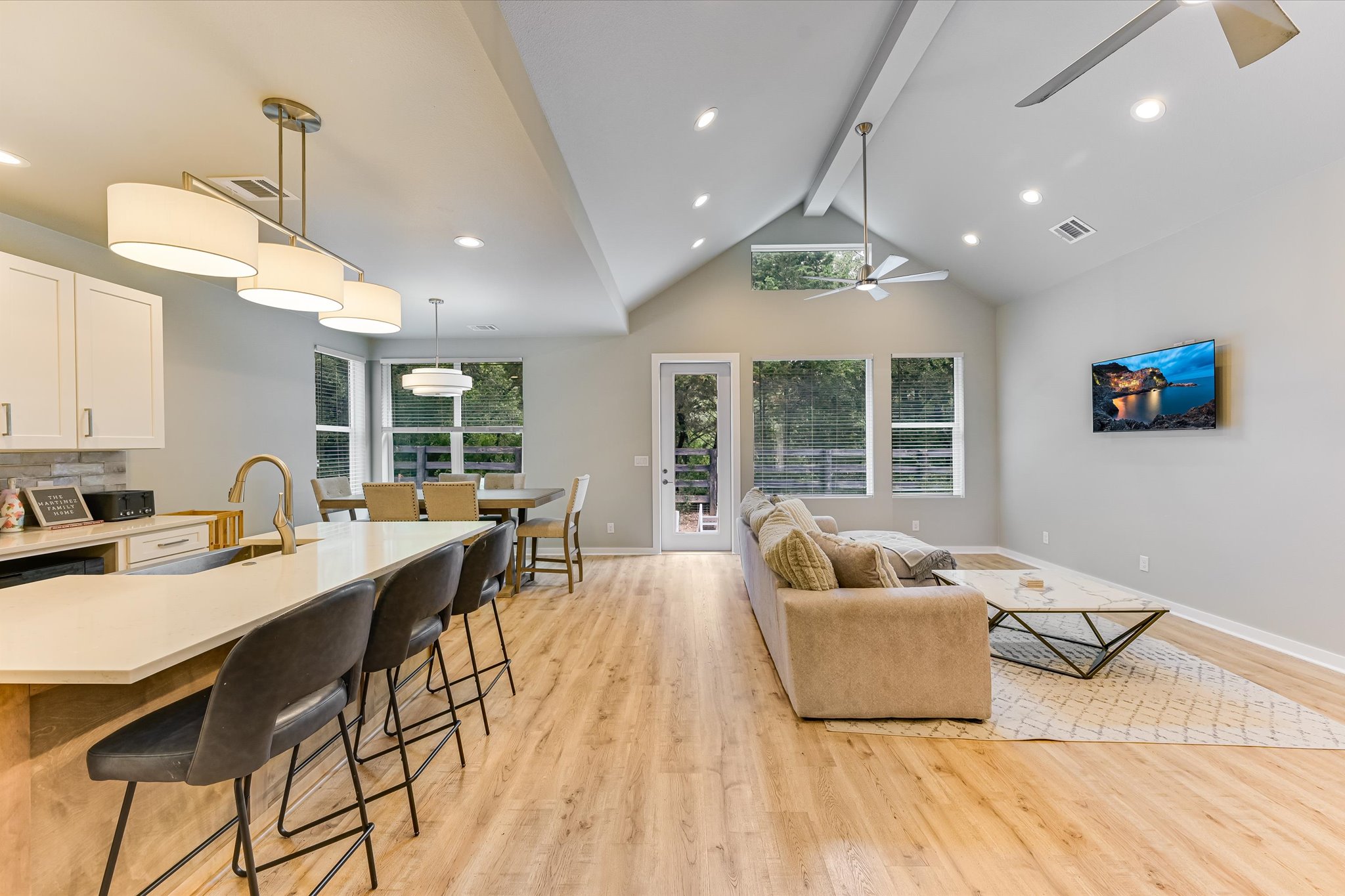 2308 Kellie Brooke Road, Unit 13 Spicewood, TX 78669 - Photo 4 of 19 Open concept living area featuring light-toned flooring, a vaulted ceiling, and recessed lighting
