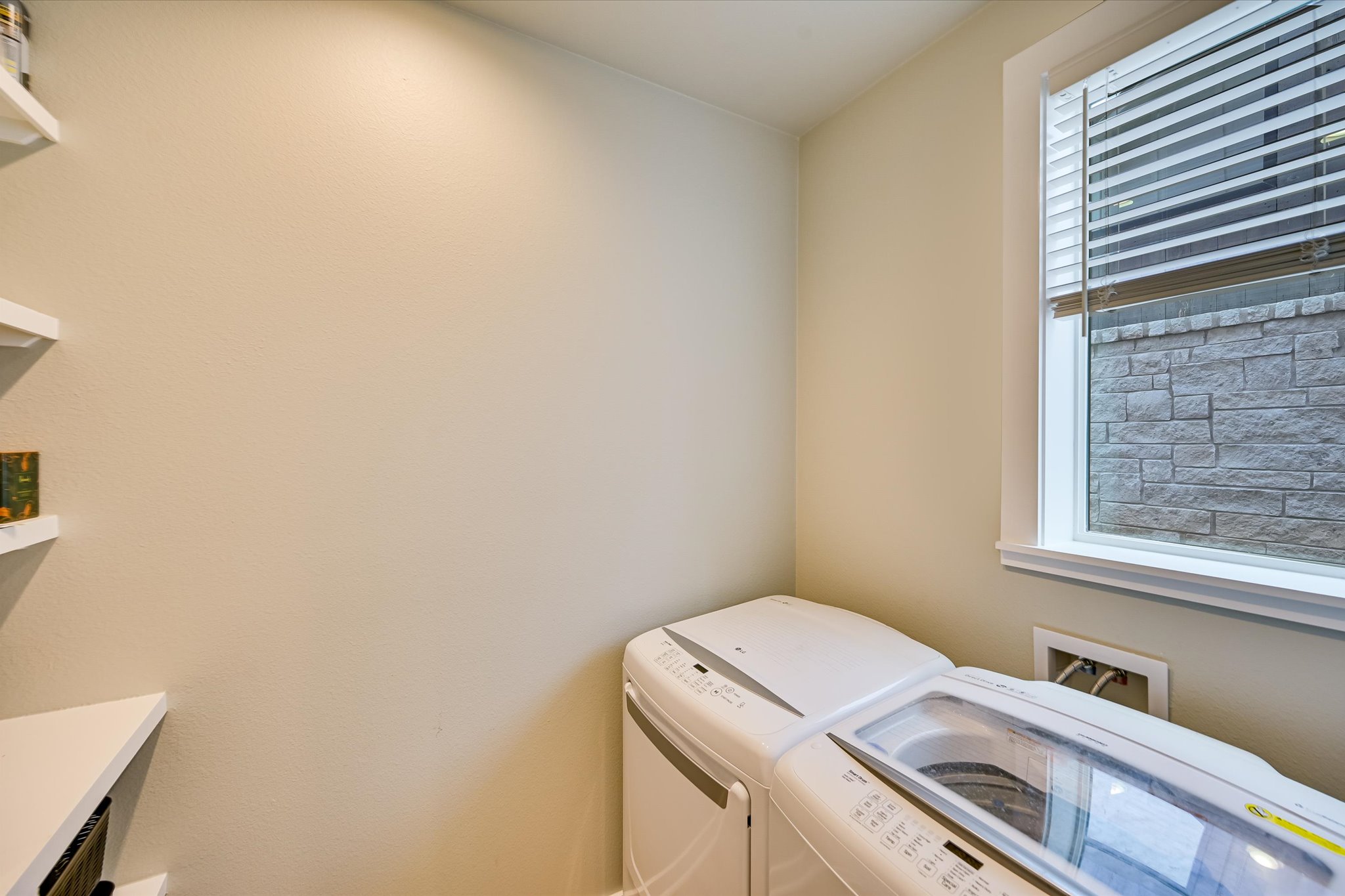 2308 Kellie Brooke Road, Unit 13 Spicewood, TX 78669 - Photo 10 of 19 The property features a dedicated space with built-in shelving and a window with blinds