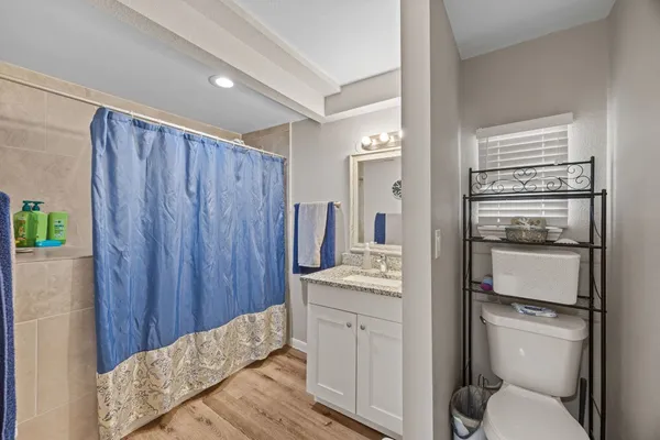 a bathroom with a sink toilet vanity and tub