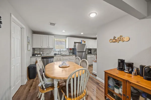 a view of a dining room with furniture and a kitchen
