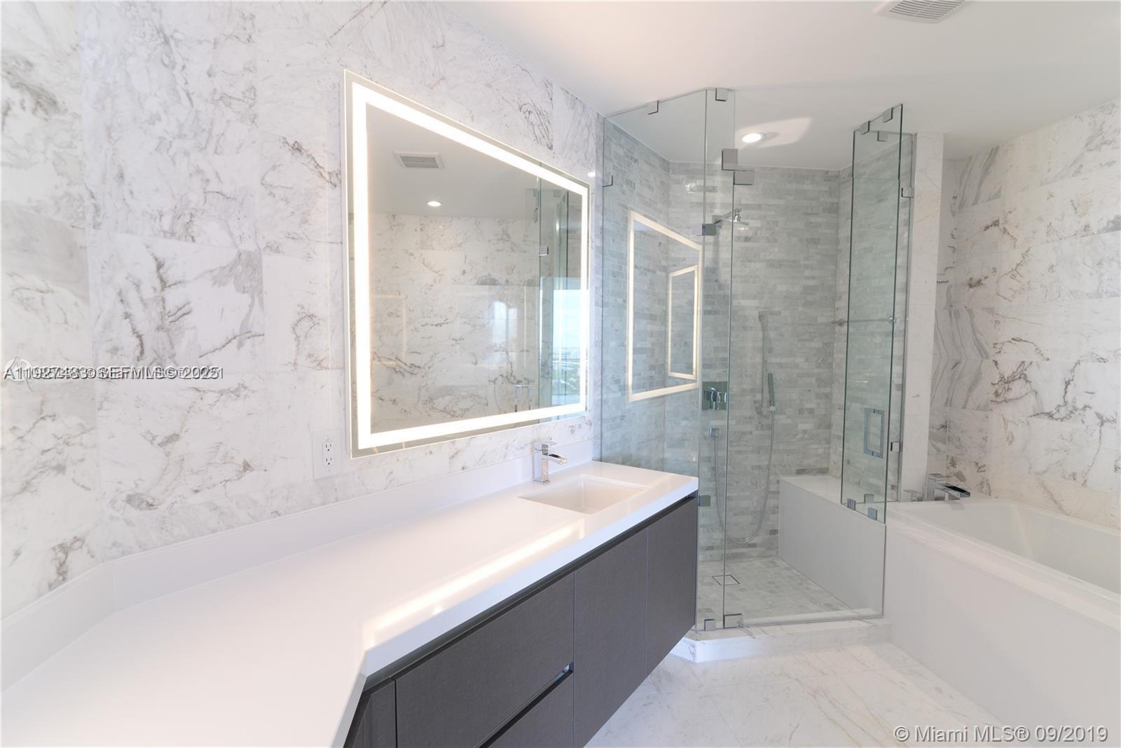 851 Northeast 1st Avenue, Unit 4110 Miami, FL 33132 - Photo 6 of 9 a bathroom with a bathtub and a sink