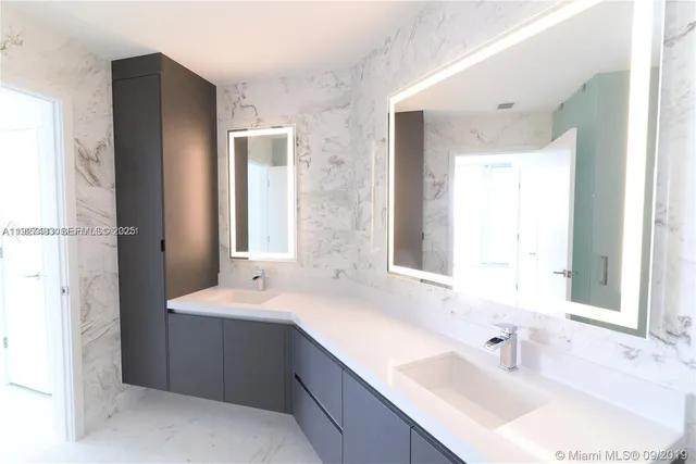 a bathroom with a double vanity sink mirror and double