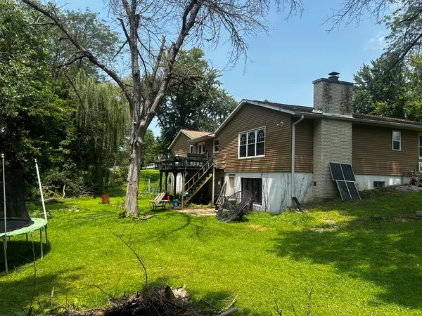 a view of a house with a yard patio and a slide