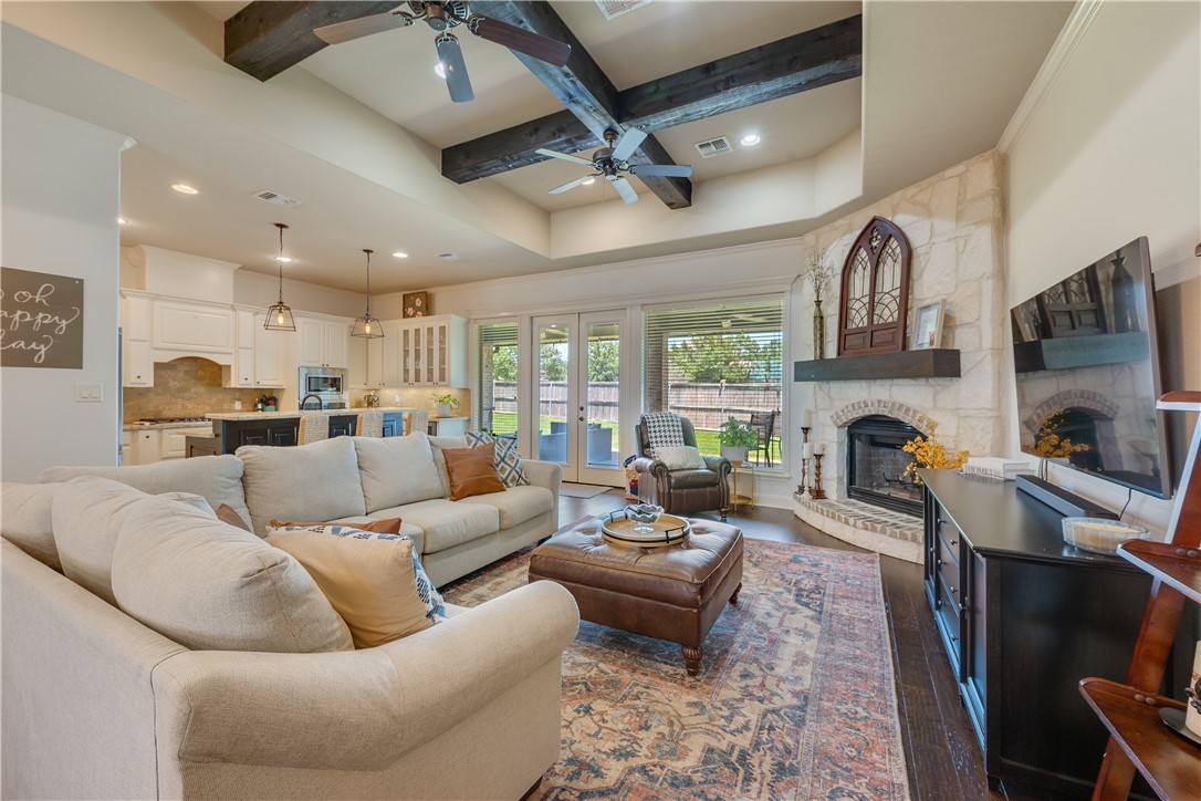 3301 Covington Court Bryan, TX 77808 - Photo 4 of 26 a living room with furniture a fireplace and a flat screen tv