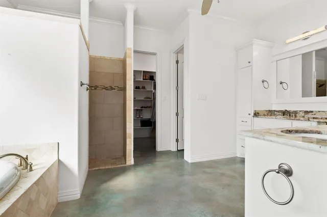 a bathroom with a granite countertop bathtub shower and sink