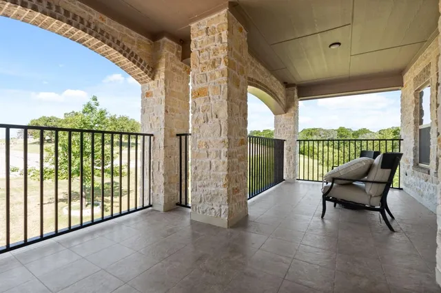 a view of a chairs and table in the balcony