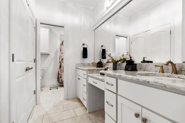 a spacious bathroom with a granite countertop sink mirror and shower