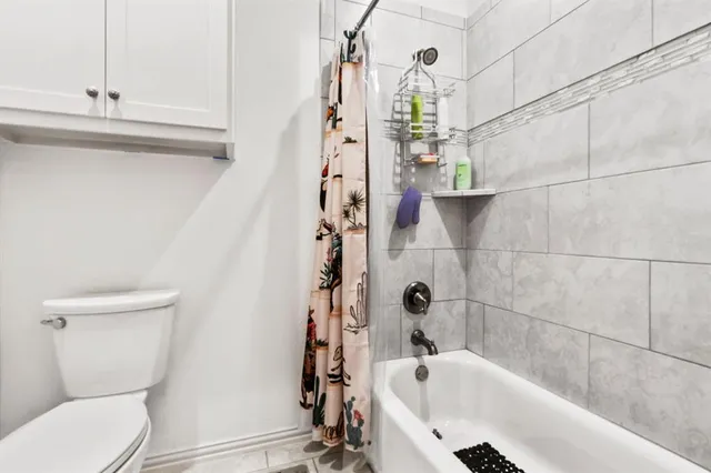 a bathroom with a bathtub and shower