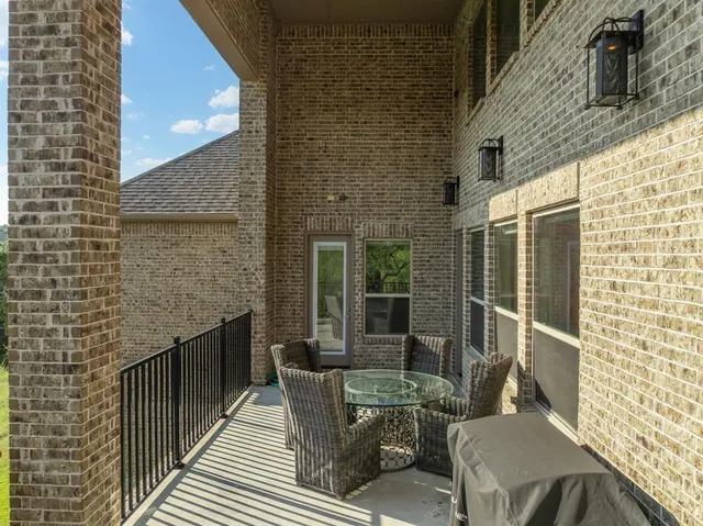 a balcony with furniture and a potted plant