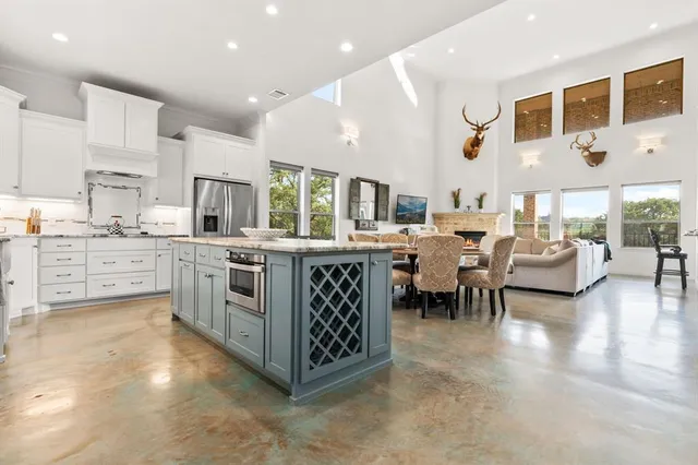 a kitchen with stainless steel appliances kitchen island granite countertop a sink and cabinets