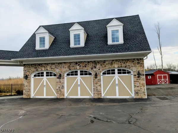 a front view of a building with parking area
