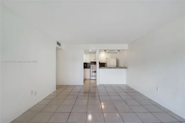 a view of kitchen with refrigerator and window