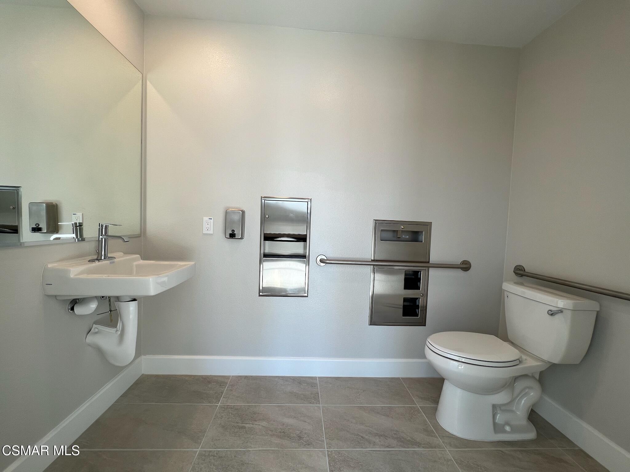 3005 Cochran Street Simi Valley, CA 93065 - Photo 14 of 57 a bathroom with a toilet a sink and mirror