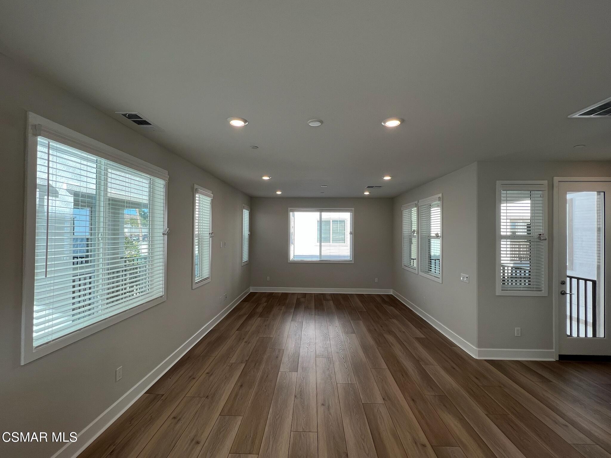 3005 Cochran Street Simi Valley, CA 93065 - Photo 21 of 57 a view of an empty room with wooden floor and a window