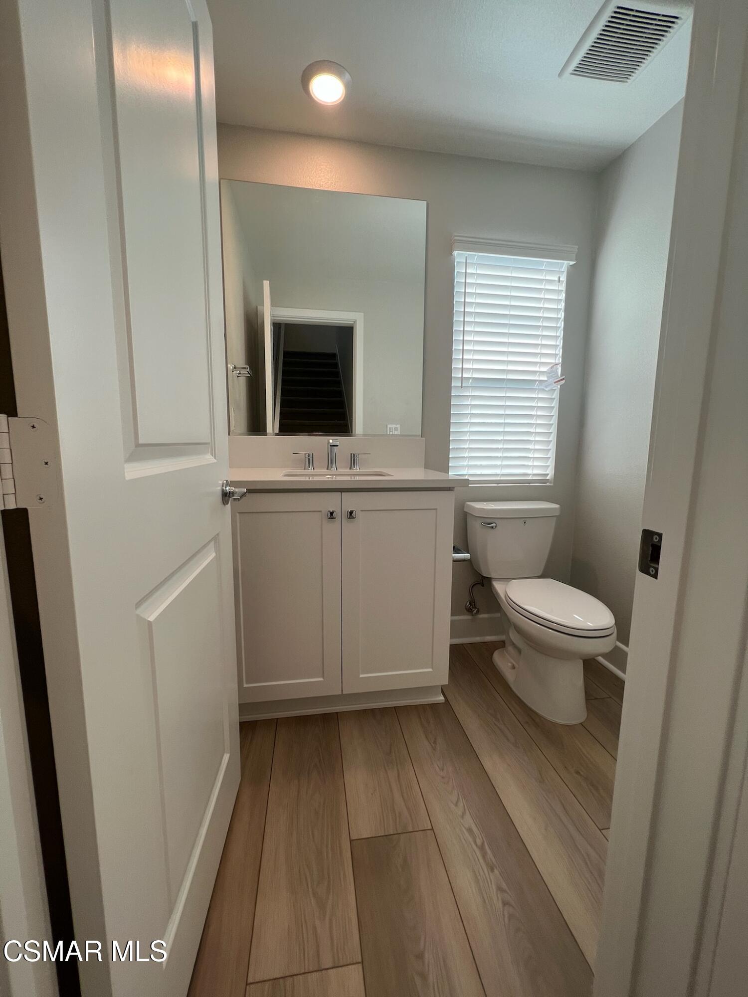 3005 Cochran Street Simi Valley, CA 93065 - Photo 24 of 57 a bathroom with a toilet sink and mirror