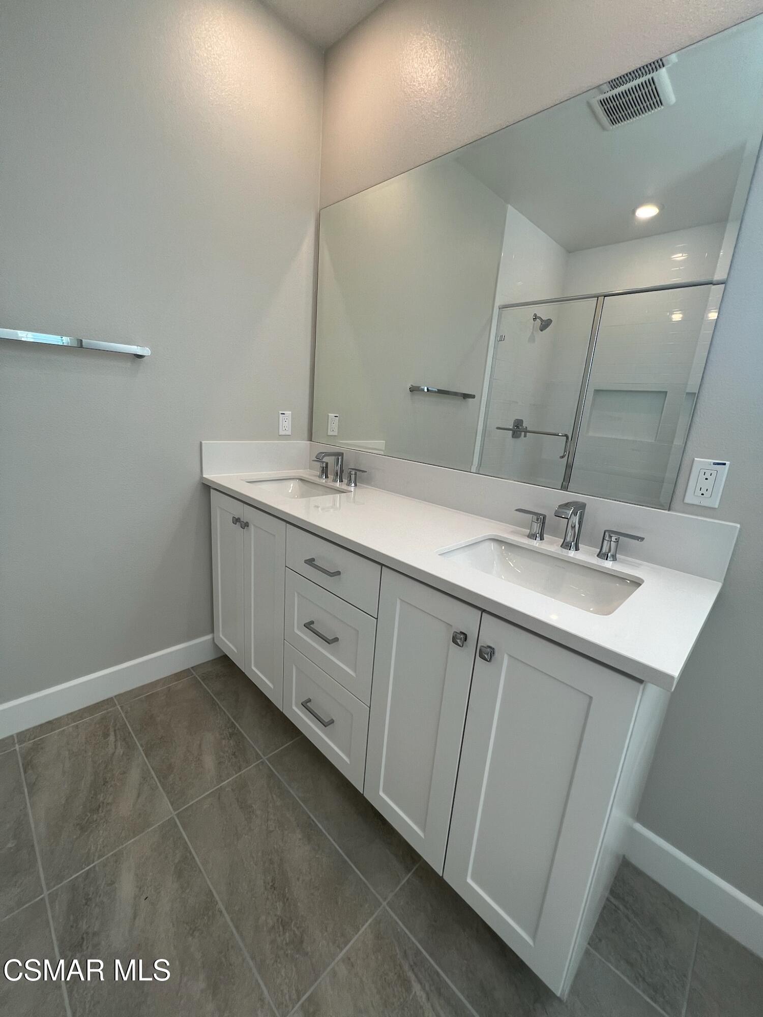 3005 Cochran Street Simi Valley, CA 93065 - Photo 35 of 57 a bathroom with a double vanity sink and mirror