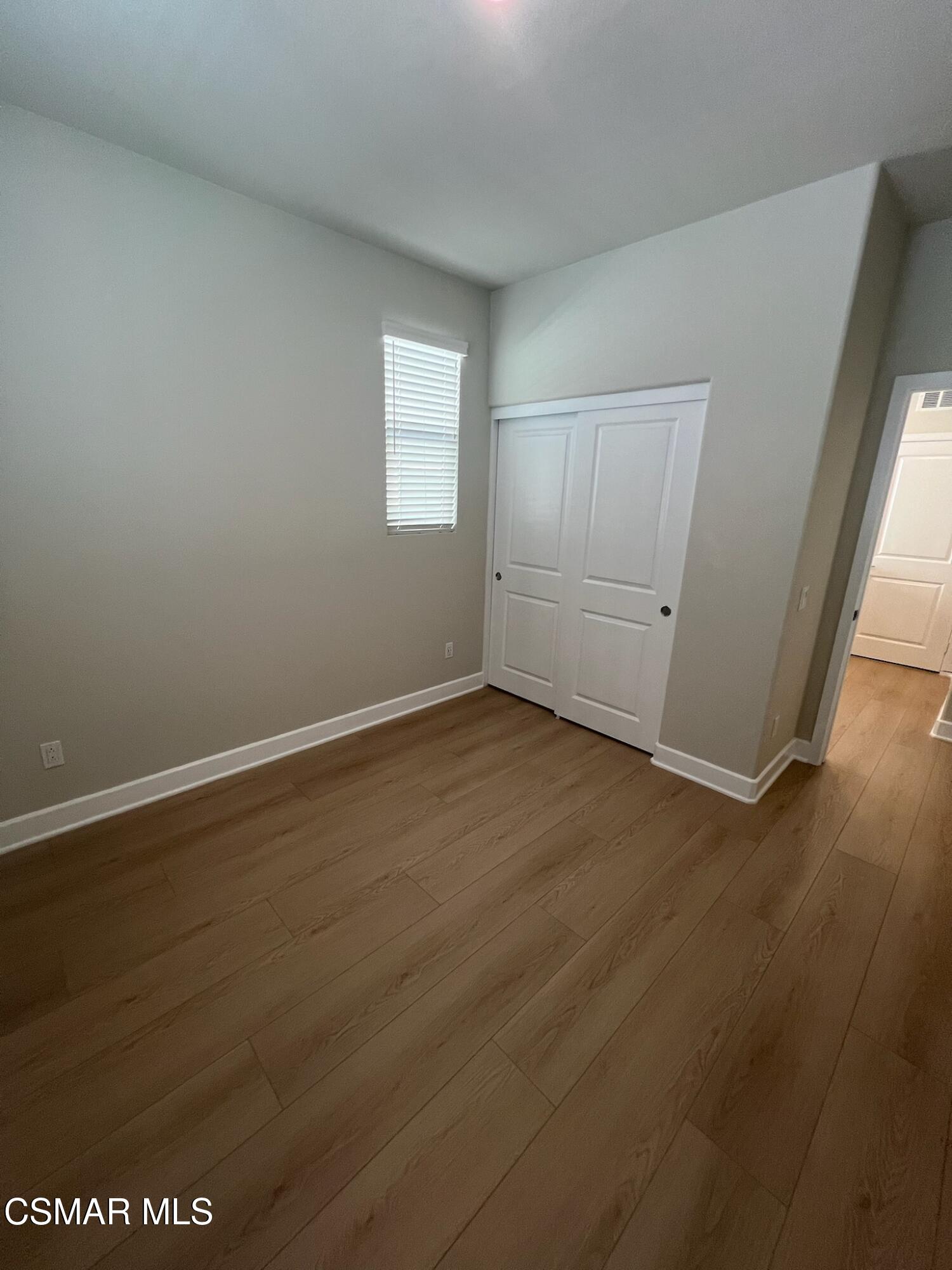 3005 Cochran Street Simi Valley, CA 93065 - Photo 39 of 57 an empty room with wooden floor and windows
