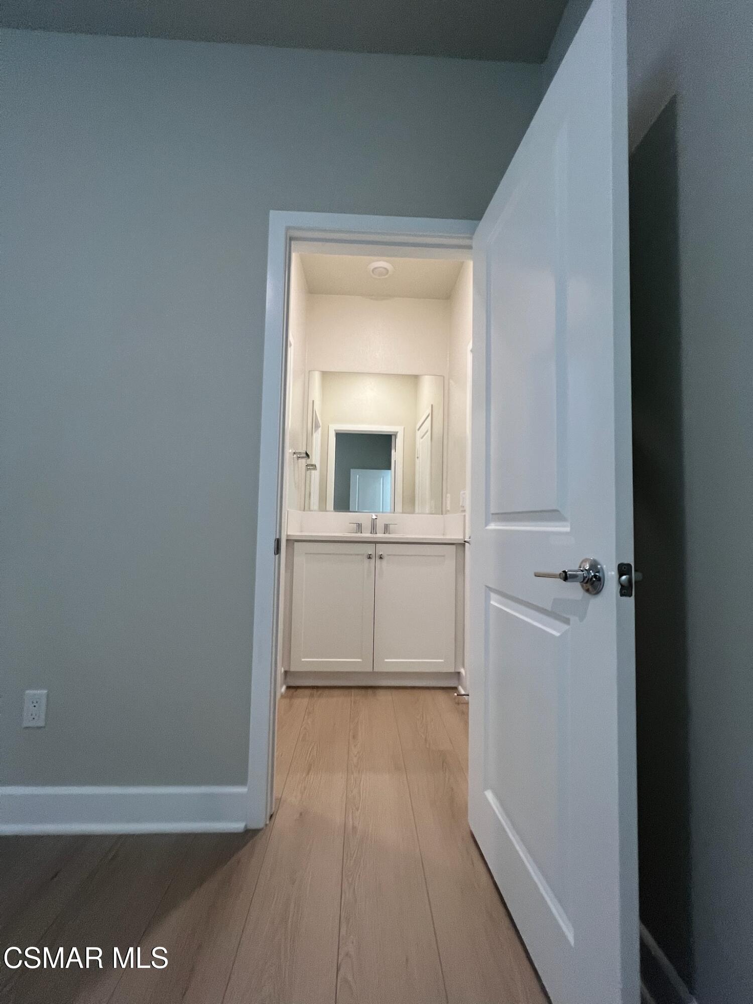 3005 Cochran Street Simi Valley, CA 93065 - Photo 42 of 57 a view of a hallway with wooden floor and a living room