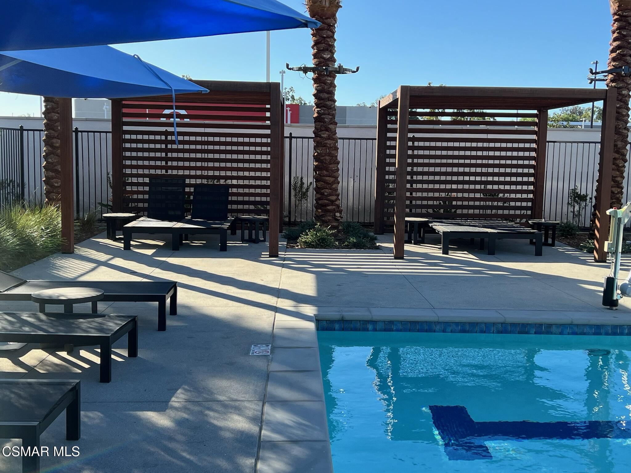3005 Cochran Street Simi Valley, CA 93065 - Photo 52 of 57 a backyard of a house with barbeque oven table and chairs
